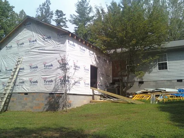Tyvek wrapped gable on a new room addition beside an existing home in Hyde Park